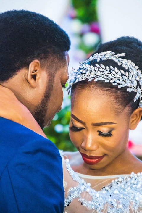 Close-up of a bride and groom sharing a tender moment, foreheads touching