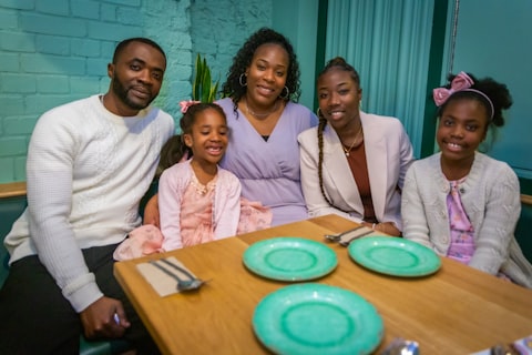 Family smiling at a set dinner table